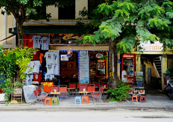 A small Hanoi café with colourful plastic stools on the pavement