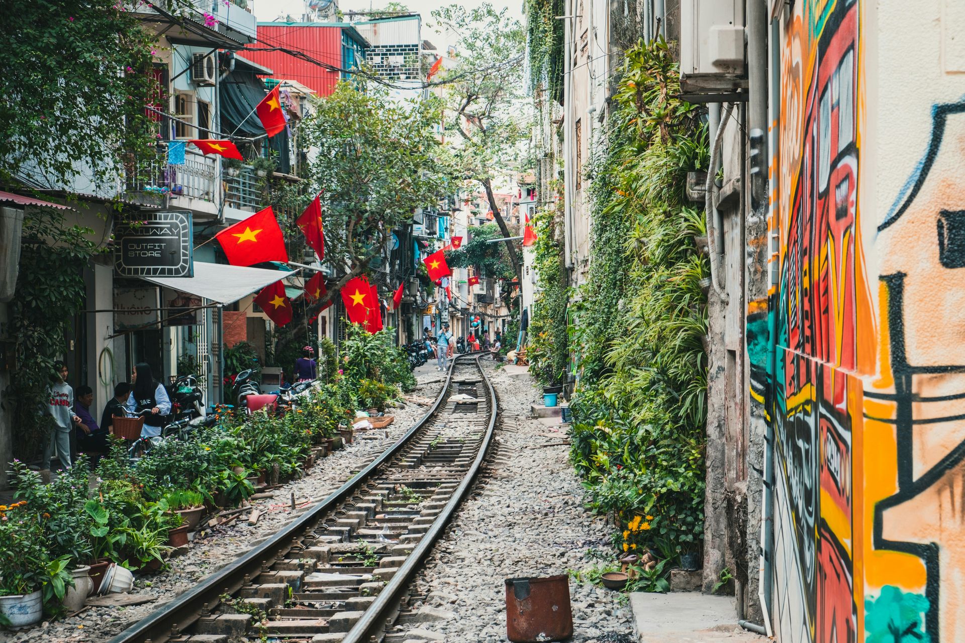 A narrow Hanoi street with a railway track running between the houses