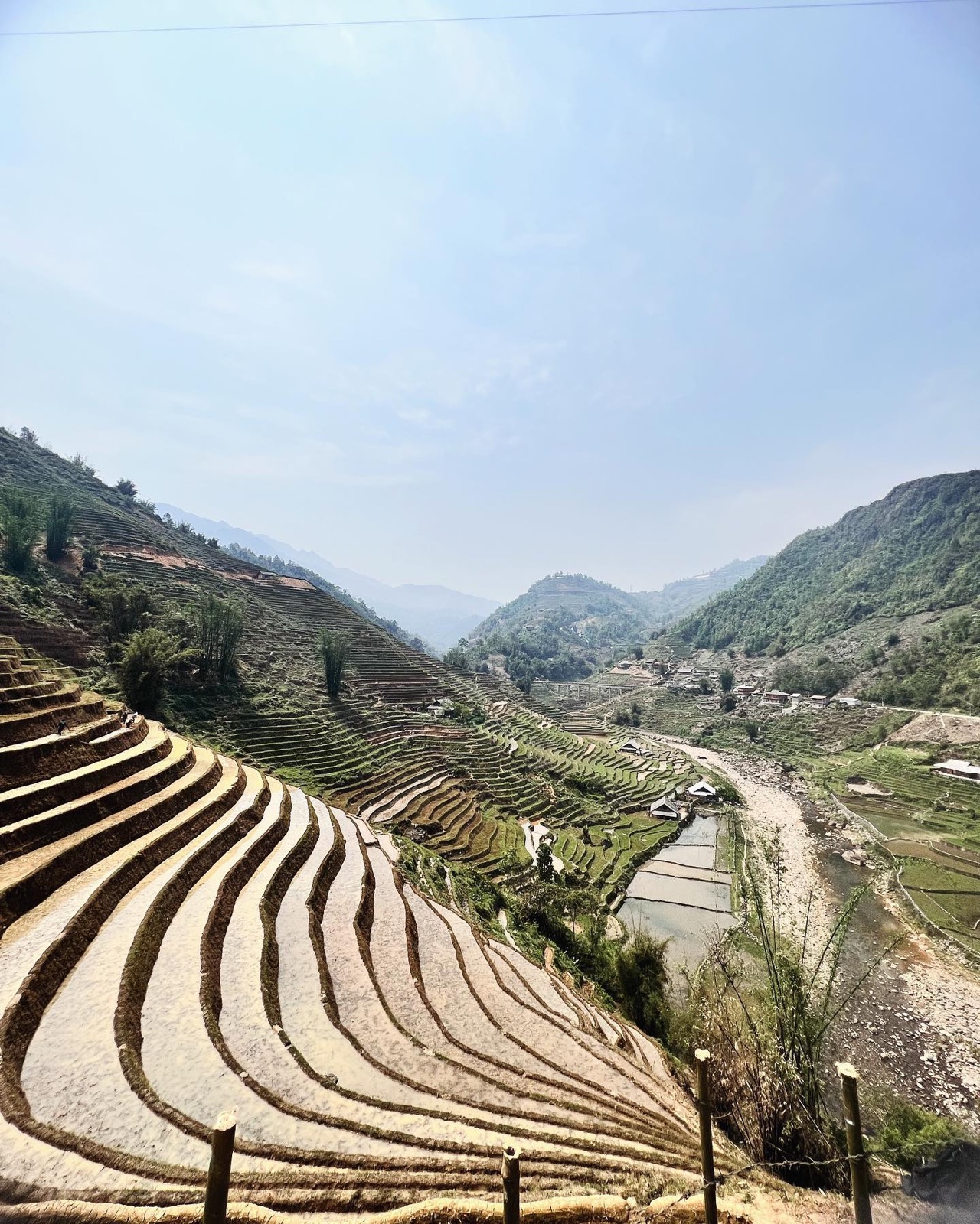 Rice terraces folding down a green mountain valley in northern Vietnam