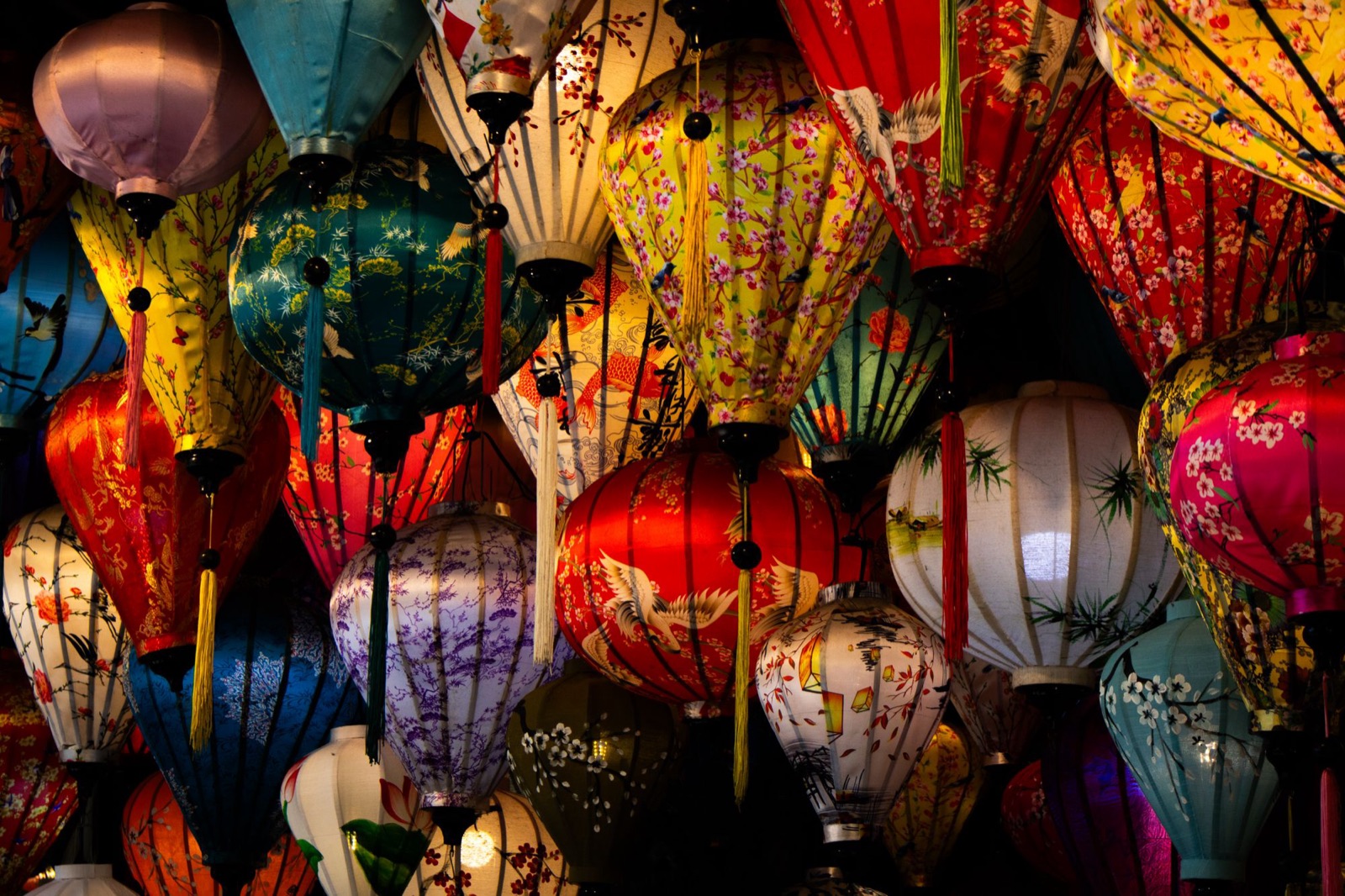 Silk lanterns of many colours glowing at the Hội An night market